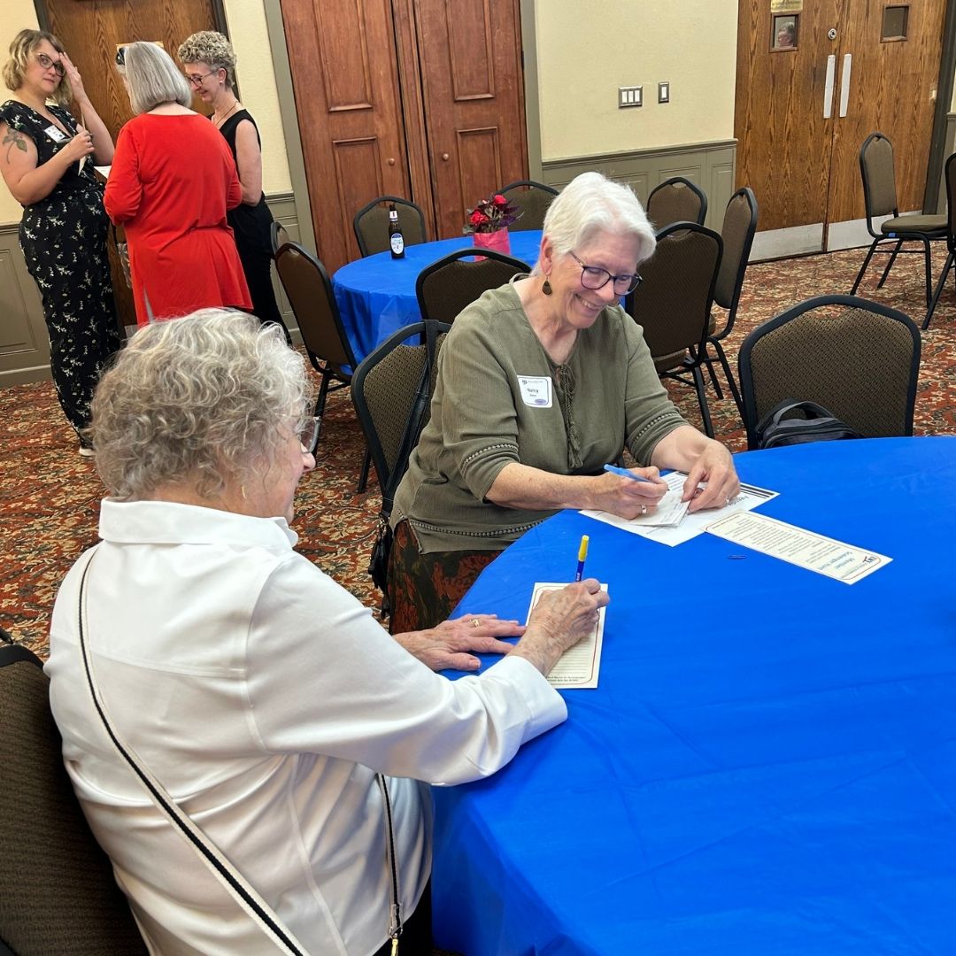 Filling out the Member Scavenger Hunt cards at the 2026 Annual Meeting